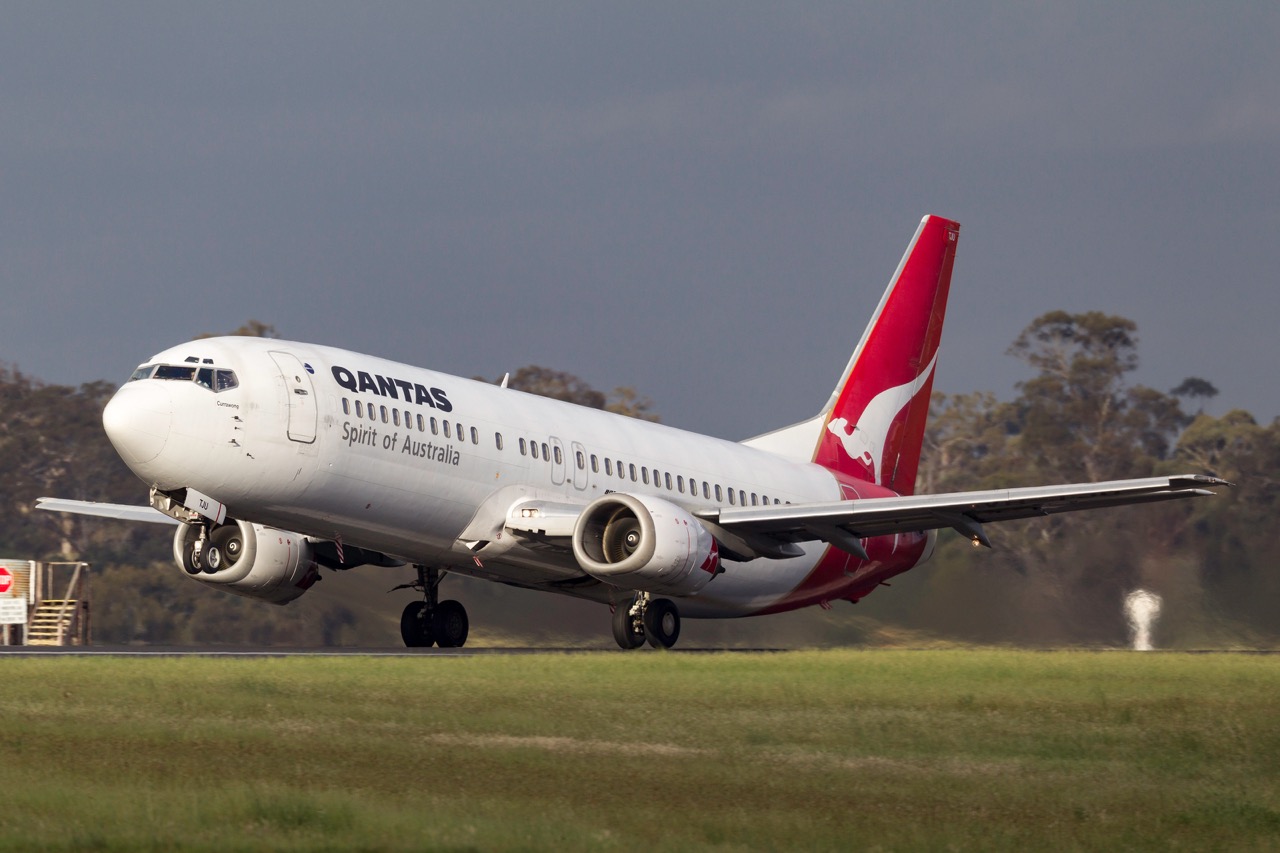Qantas aircraft taking off from Melbourne Airport runway - luxury chauffeur airport service